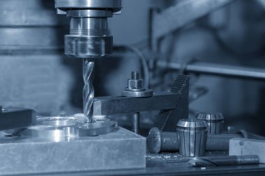 The drilling process on NC milling machine with brass material. The metal working concept on the milling machine.