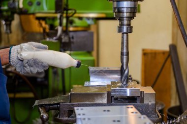 Sıvı kayganlaştırıcı ile NC değirmen makinesinde sondaj işlemi. Değirmen makinesindeki metal çalışma konsepti..