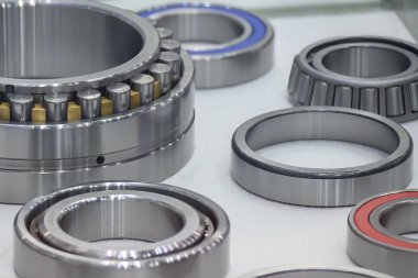 The cylindrical rolling bearing parts in light blue scene. The heavy mechanical part manufacturing concept.