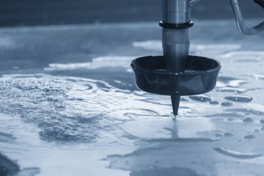 Açık mavi sahnede aşındırıcı su jeti kesme makinesi. CNC makinesiyle çalışan yüksek teknoloji levha metali.