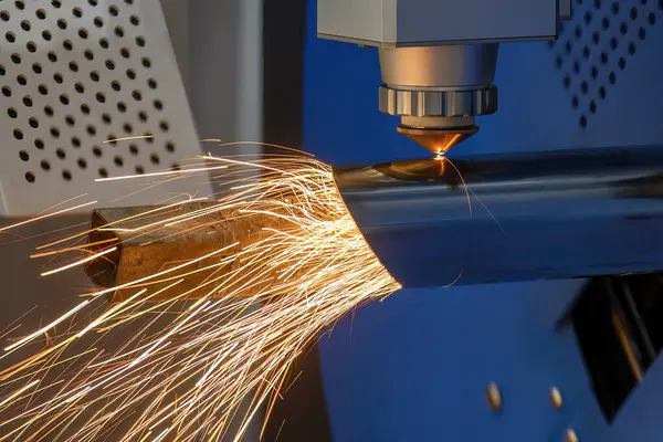 Close up scene the fiber laser cutting machine cut the stainless steel tube and sparkling light. The hi-technology sheet metal manufacturing process by laser cutting machine.