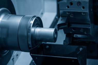CNC torna makinesi metal şaft parçalarını kesiyor. CNC dönüşüm makinesinin yüksek teknolojili metal işlemesi .