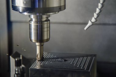 The CNC milling machine rough cutting the injection mold parts by indexable tools. The mold and die manufacturing process by machining center.