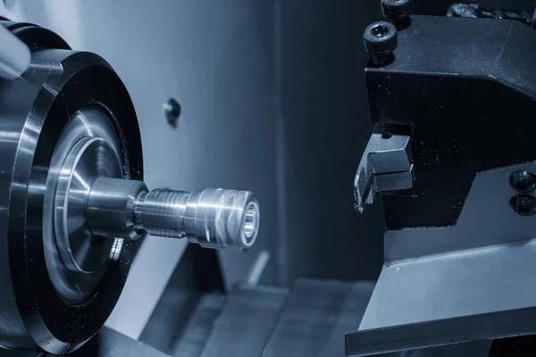 The  multi tasking CNC lathe machine swiss type slot cutting the brass fitting parts. The hi-technology metal working processing by CNC turning machine .