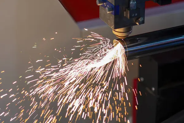 The fiber laser cutting machine cut the stainless steel tube and sparkling light. The hi-technology sheet metal manufacturing process by laser cutting machine.