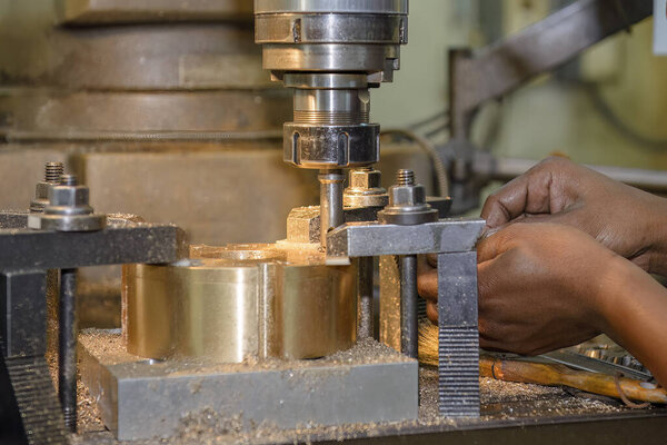 The boring process on NC milling machine with brass material. The metal working concept on the milling machine.