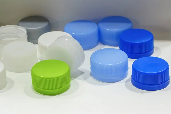 The group of multi-color plastic bottle caps. The PET bottle manufacturing process concepts.