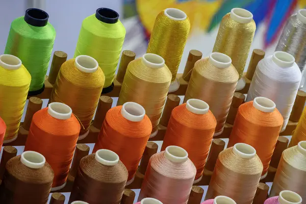 Close up the multi-color the group of industry bobbin thread. The textile production concept.