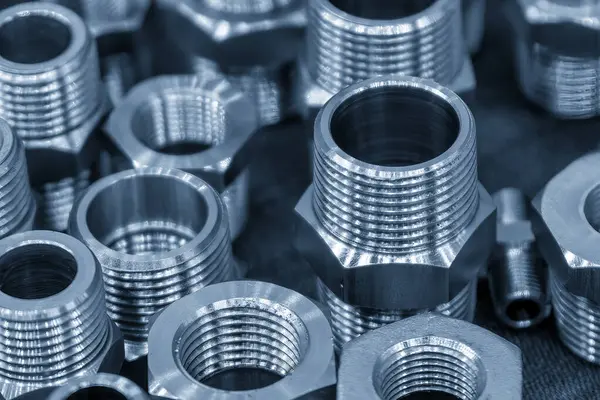 Açık mavi sahnedeki çelik su boru bağlantı parçaları yığını. Yüksek duyarlı parça üretim süreci kavramı. 