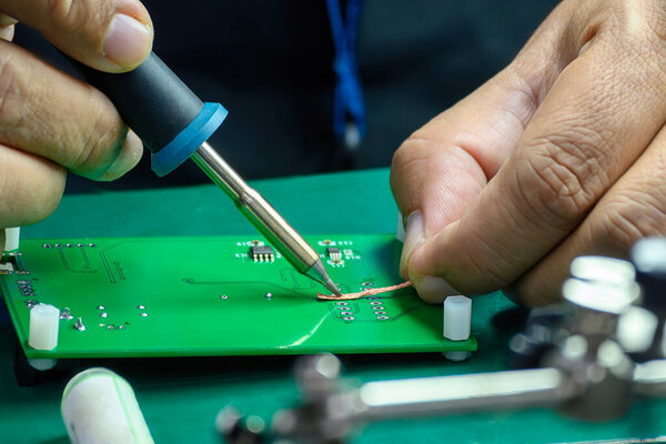 Close up scene the soldering operation by skill operator. The repair work circuit board by skill operator. 