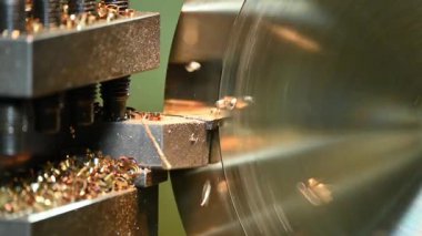 Closeup scene the lathe machine finish cut the brass parts by lathe tools. The metalworking process by turning machine.