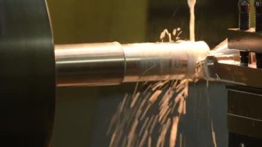 Tava sahnesi torna makinası metal şaft parçalarını sıvı soğutucu metoduyla kesiyor. Makineyi döndürerek metal işleme süreci.