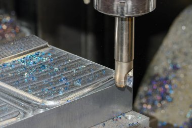 The CNC milling machine rough cutting the injection mold parts by indexable tools. The mold and die manufacturing process by machining center.