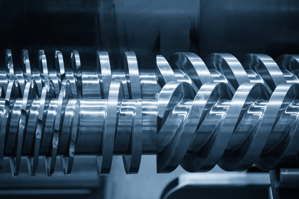 Close up scene body of the barrel screw of injection machine spare parts in the light blue scene. The manufacturing concept injection machine .