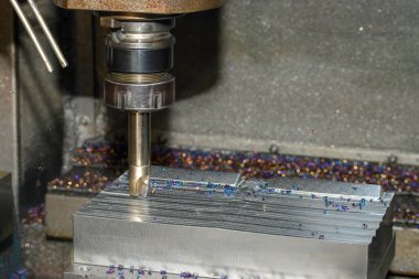 The CNC milling machine rough cutting the injection mold parts by indexable tools. The mold and die manufacturing process by machining center.