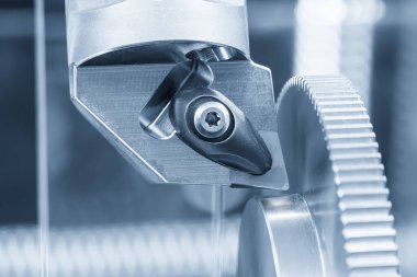 CNC Torna Makinesi, açık mavi sahnede metal dişli parçalarını kesiyor. CNC dönüşüm makinesinin yüksek teknolojili metal işlemesi .