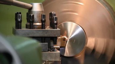 Kapanış sahnesi torna makinesi torna tezgahlarıyla metal parçaları kesiyor. Makineyi döndürerek metal işleme süreci.