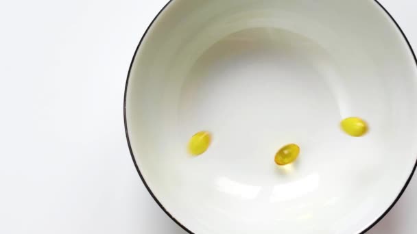 Golden Pills Omega Glass Medicine Healthcare Concept White Background Close — Stok video