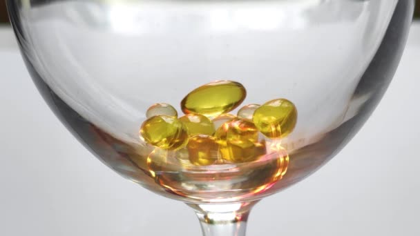 Golden Pills Omega Fall Glass Medicine Healthcare Concept White Background — Stock video