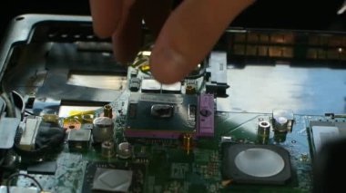 Hands fixing motherboard of pc or laptop notebook close in service