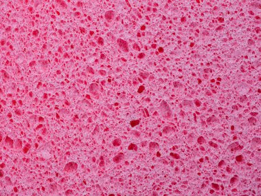 Çamaşır süngerinin yakın çekim dokusu. Pembe soyut arkaplan
