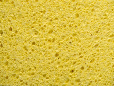Abstract background with texture of yellow washing sponge in close-up clipart