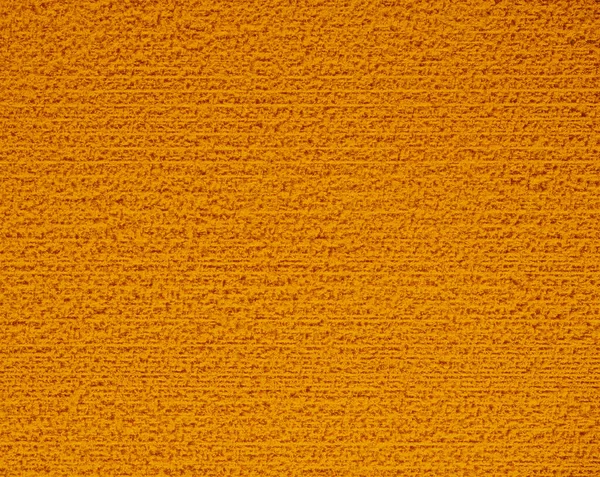 Rough abstract background with orange wash sponge close-up