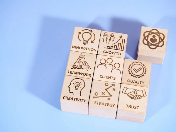 Symbols of core corporate values on wooden cubes