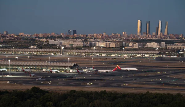 stock image Madrid skyline during sunrise. Airport at front and four towers in the background. Copy space.