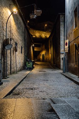 cobbled wet street at night in the old town of Porto.