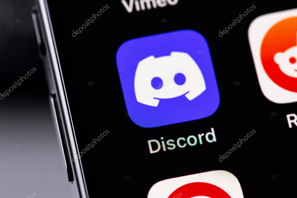 Discord mobile icon app on a screen smartphone iPhone closeup. Discord is a cross-platform proprietary instant messaging system with support for VoIP and video conferencing. Batumi, Georgia - November 4, 2023