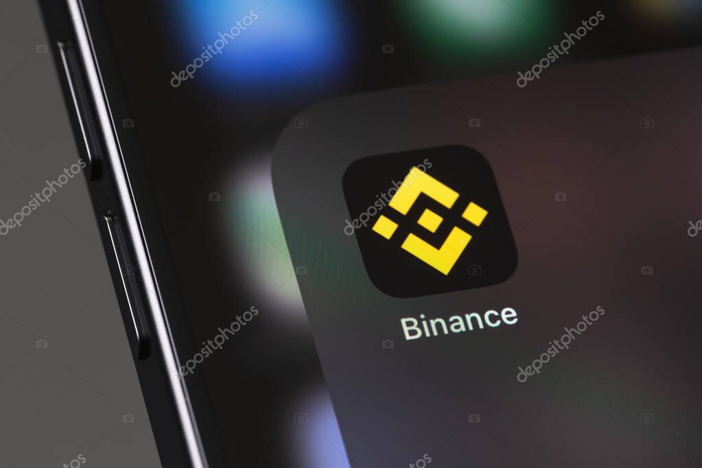 Binance logo mobile icon app on a screen smartphone iPhone closeup, macro. Binance - one of the largest cryptocurrency exchange on the market. Batumi, Georgia - December 3, 2023