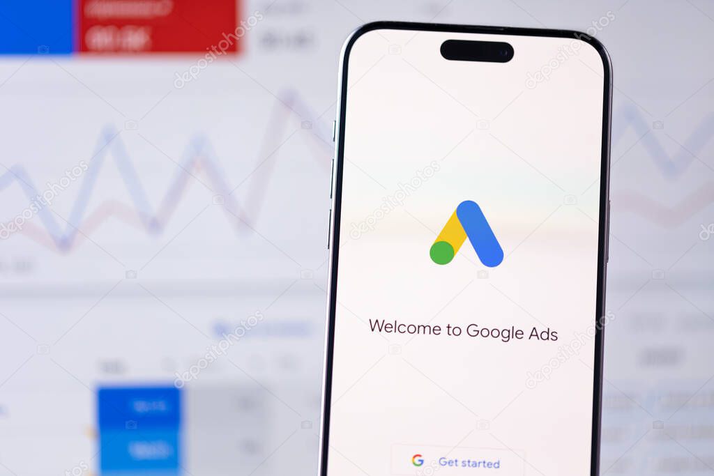 Google Ads logo app on a screen smartphone iPhone and Macbook background. Ads or Ad, AdWords is a service of contextual, basically, search advertising from Google. Batumi, Georgia - November 26, 2023
