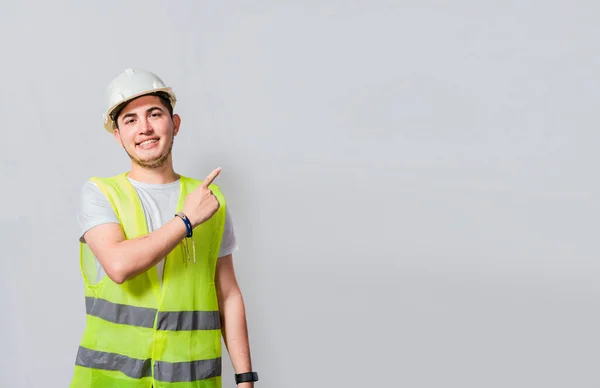 stock image Engineer man pointing to side. Builder engineer pointing finger to the right isolated, Portrait of engineer man pointing aside, Construction engineer with vest pointing at an advertisement