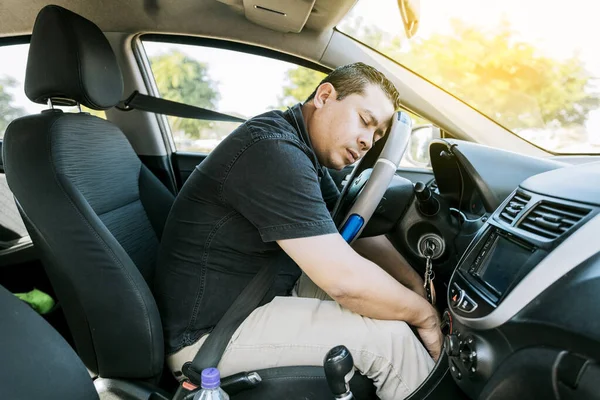 View of a driver asleep at the wheel. Tired driver with closed eyes at the wheel, concept of man asleep while driving. A drowsy driver at the wheel, a tired person while driving