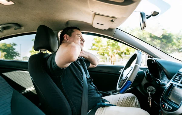 Exhausted driver with pain and stress. Man in the car with neck pain. Exhausted driver with neck pain in traffic, Driver people with neck pain in car