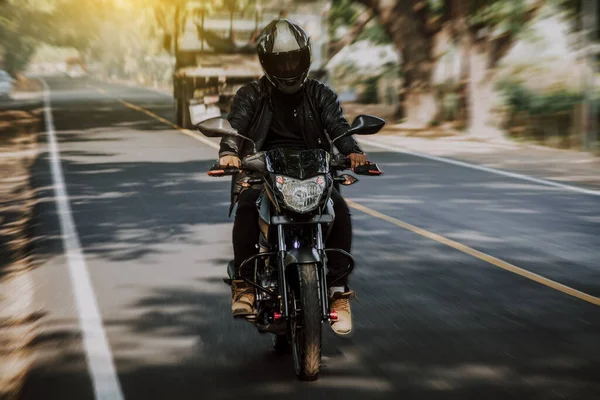 stock image Motorcyclist driving at high speed on the street. Motorcycle driver at full speed on the highway.