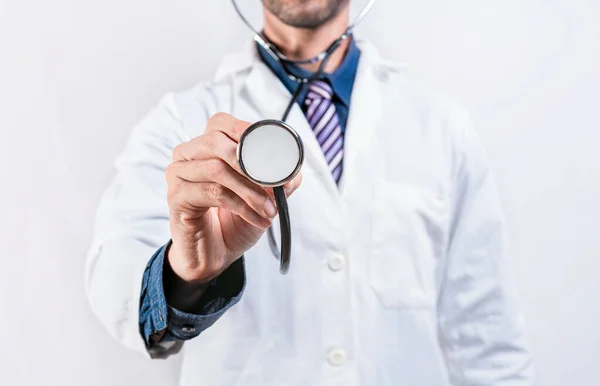 Close up of doctor holding stethoscope isolated. Unrecognizable doctor holding a stethoscope on white background