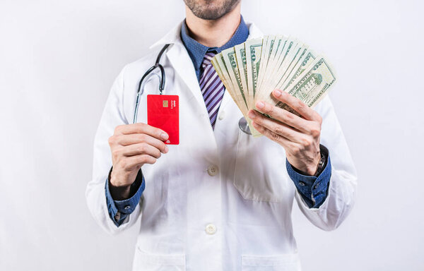 Unrecognizable doctor holding money and credit cards isolated. Doctor hands holding credit card and money isolated