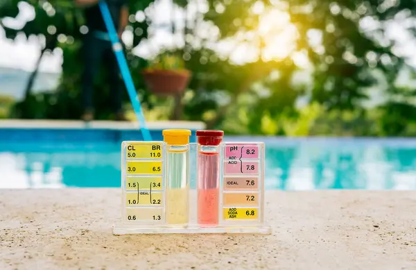 Tester kit to measure chlorine and ph in swimming pools. Pool water PH tester kit on the edge of the swimming pool