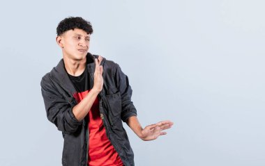 Disgusted man with rejection gesture, pulls palms in rejection, displeased guy rejecting something