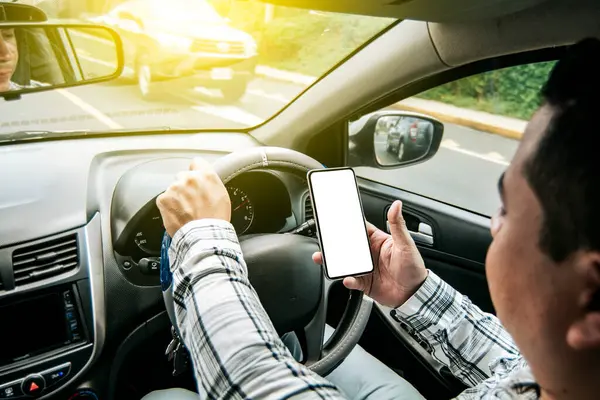 stock image Distracted driver using the cell phone while driving, Man using his phone while driving, Person holding the cell phone and with the other hand the steering wheel, Concept of irresponsible driving