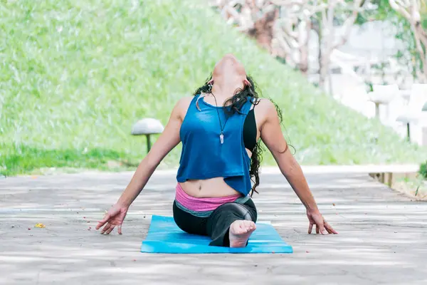 stock image Girl sitting doing split meditation yoga outdoors, woman doing side split yoga outdoors, young woman doing side split yoga