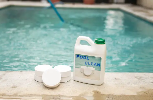 stock image Pool cleaning chlorine tablets kit, pool cleaning chlorine tablets close up on the edge of a swimming pool, pool sanitizing chlorine tablets concept