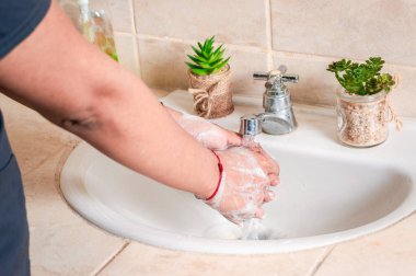 Close up of a person washing their hands with soap, concept of correct hand washing, ways to prevent covid19