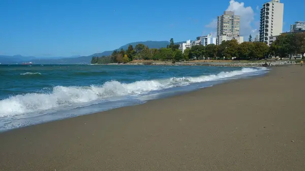Vancouver English Bay Public City Beach on a Sunny Day. Waves Crashing on Shore.