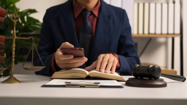 Stock image Male lawyer working with law book, A legal binding, Unilateral contract, Multilateral, Non-reciprocal contract, Default, Obligation, Power of attorney, Defense of a prescription, Court decree