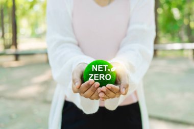 Çevre, sosyal ve yönetim (ESG) değerlerini yansıtan, daha yeşil bir gelecek için net sıfır kavramını teşvik eden, yeşil bir top tutan, sürdürülebilir bir yaşam.