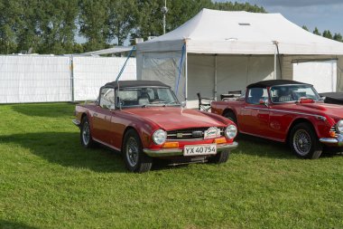 Copenhagen, Denmark - August 02, 2024: A red TR6 vintage car at the Copenhagen Historic Grand Prix clipart