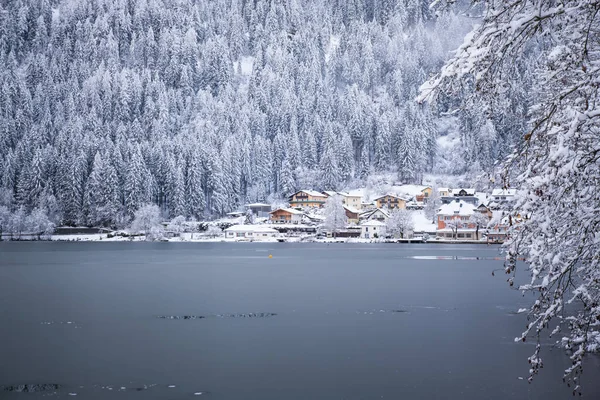 Panorama view of Feldsee lake and mountain in daylight with snow. Landscape view of famous Feld am See lakeside town during winter Austria Europe